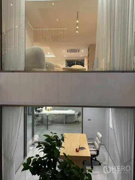 Home Office for sale in Chatuchak, Bangkok - Night view through the atrium showing office below and lounge above.