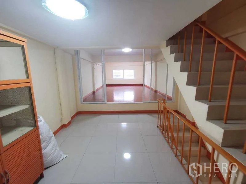 Shophouse for rent in Suan Luang, Bangkok - Multipurpose room with glass-enclosed space and stair access.