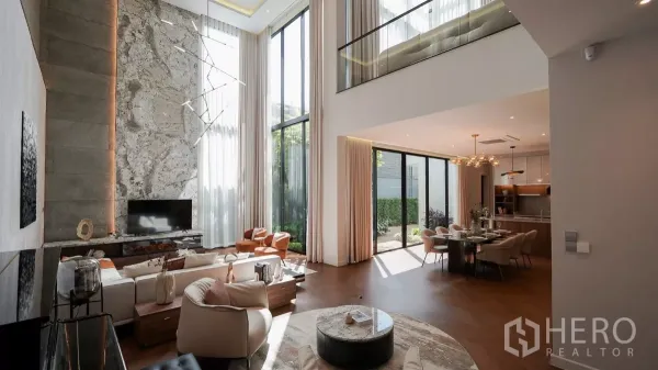Detached House for rent or sale in Bang Kapi, Bangkok - Open-plan living and dining with floor-to-ceiling windows opening to a private garden.