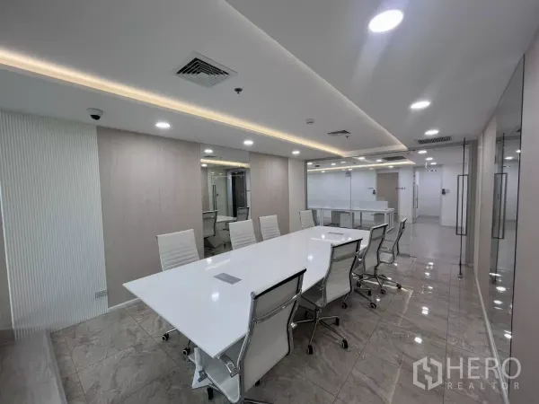 Office Space for rent in Din Daeng, Bangkok - Conference room opening to the open-plan office through clear glass partitions, with recessed lights and tiled floors.