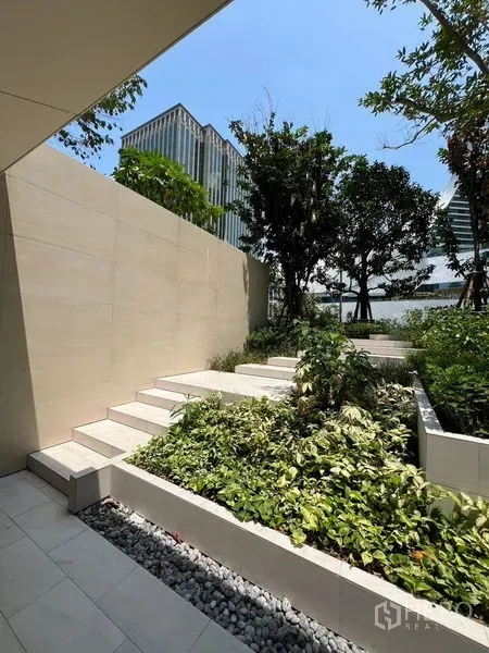 Retail Space for rent in Pathum Wan, Bangkok - Landscaped terrace with light stone steps and greenery framed by city towers.