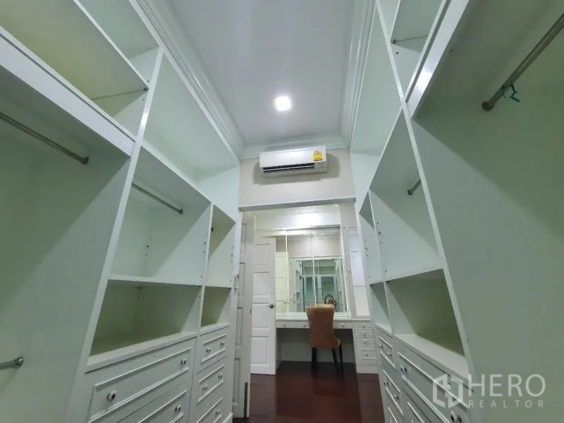 Detached House for rent in Bang Phli, Samut Prakan - Long walk-in closet corridor with shelves and a vanity station