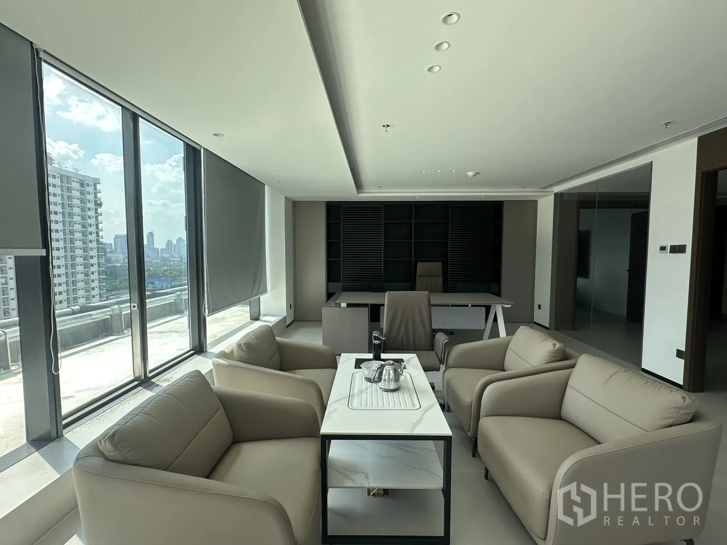 Office Space for rent in Din Daeng, Bangkok - Executive office with lounge seating and floor-to-ceiling windows overlooking the city.