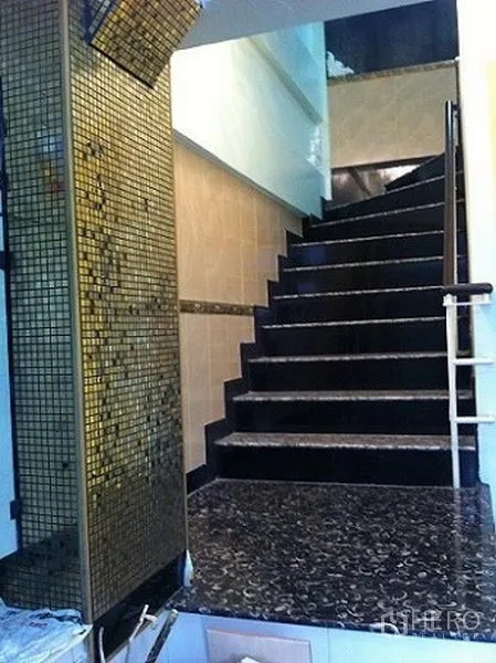 Home Office for rent or sale in Sathon, Bangkok - Polished dark stone staircase with golden mosaic accent wall leading to upper floors.