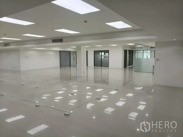 Office Space for rent in Chatuchak, Bangkok - Corner of office with a glass-walled room, double doors, and reflective floor
