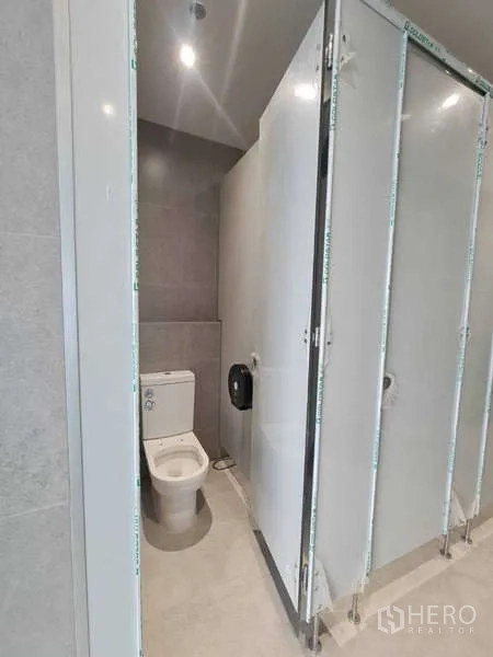 Office Space for rent in Chatuchak, Bangkok - Clean tiled restroom cubicles inside the office building.