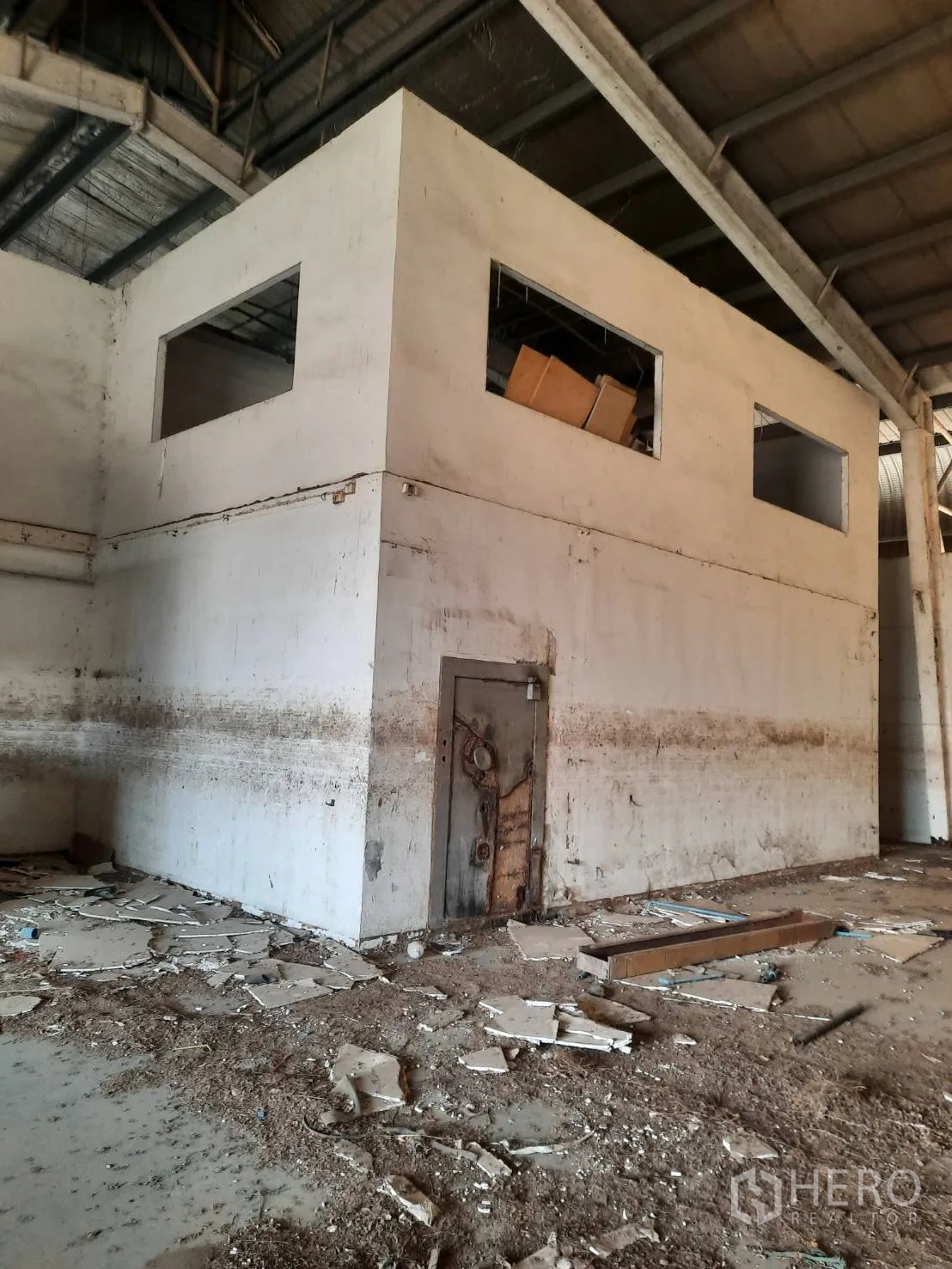 Factory for sale in Bang Pa-in, Phra Nakhon Si Ayutthaya - Two-story internal office block with a metal door inside the factory hall.