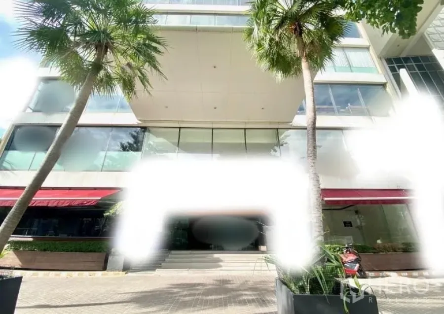 Retail Space for rent - Modern glass-front retail building entrance with palm trees and steps in Bang Rak, Bangkok.