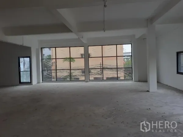 Office Space for rent in Khlong Toei, Bangkok - Spacious shell office with large glazed panels, concrete subfloor and a side window ready for fit-out.