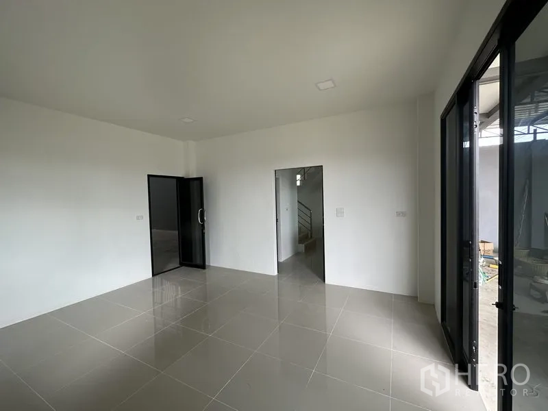 Warehouse for rent in Lam Luk Ka, Pathum Thani - Office room view showing internal doors and glass partition entry.