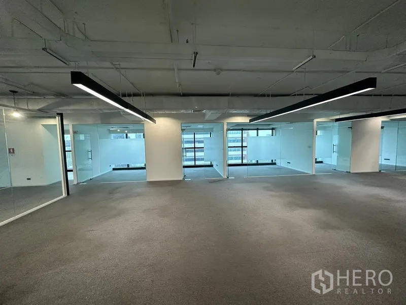 Office Space for rent - Open workspace with LED strip lights and multiple glass-walled rooms.