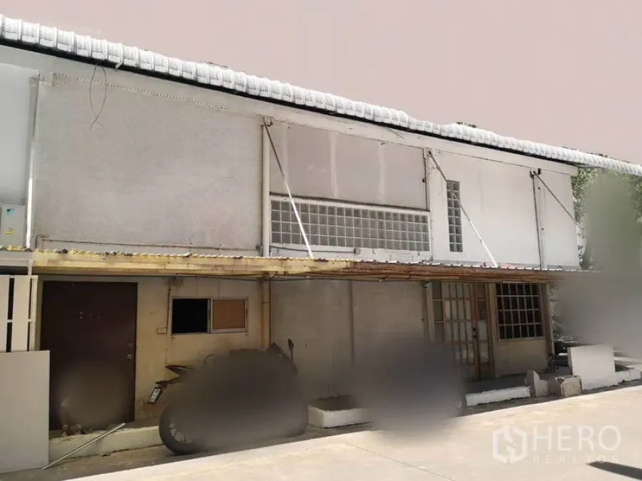 Retail Space for rent in Khlong Toei, Bangkok - Two-storey commercial building exterior with awning, glass‑block windows and ground-level access within a private compound.