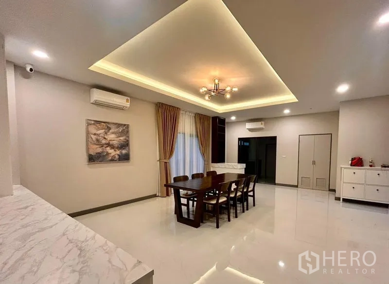 Detached House for rent - Dining area with tray ceiling lighting and a six-seat wooden table.