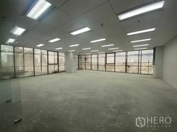 Office Space for rent in Phra Khanong, Bangkok - Unfurnished open-plan office with large windows and grid ceiling lights.