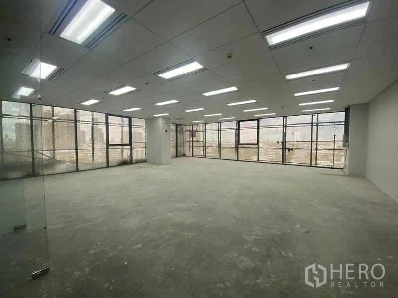 Office Space for rent in Phra Khanong, Bangkok - Unfurnished open-plan office with large windows and grid ceiling lights.