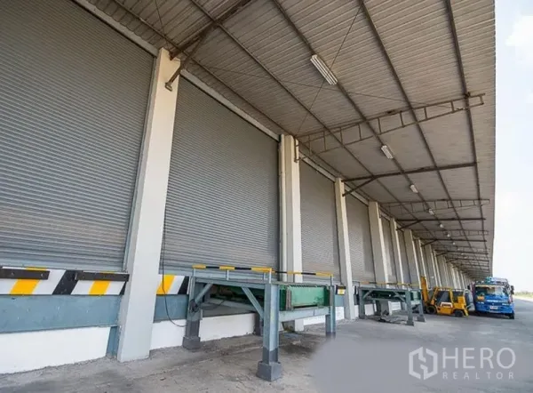 Warehouse for rent in Phra Nakhon Si Ayutthaya - Row of dock-high loading bays with roller shutter doors and dock levelers at the warehouse.