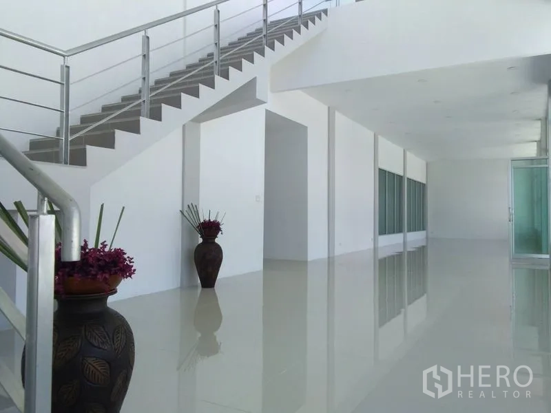 Factory for sale in Bang Sao Thong, Samut Prakan - Ground-floor reception area with staircase and decorative vases.