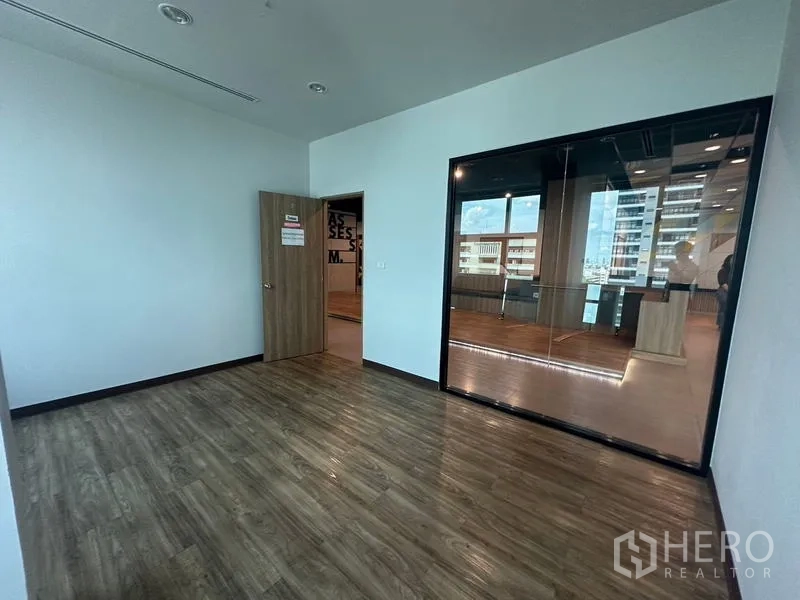 Office Space for rent in Ratchathewi, Bangkok - Private room with dark-tinted glass wall facing the main office.