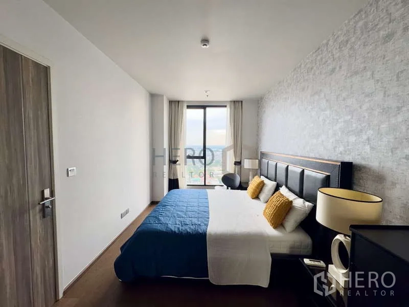 Condominium for rent - Spacious bedroom facing a floor-to-ceiling window with open city outlook.