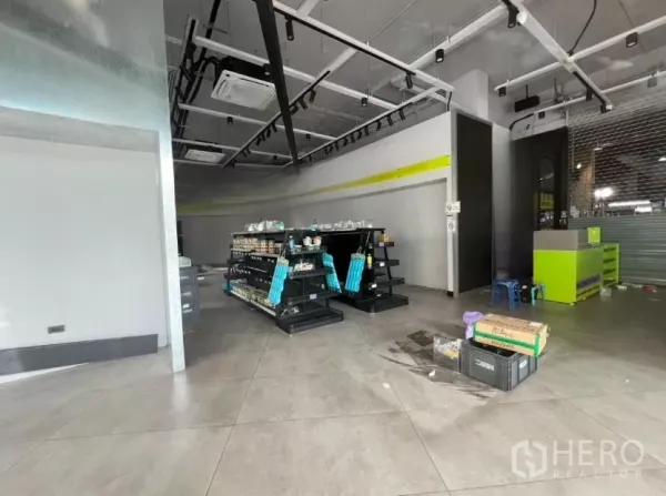 Retail Space for rent - Retail floor with display shelving, tiled flooring, track lighting and a service counter ready for use.