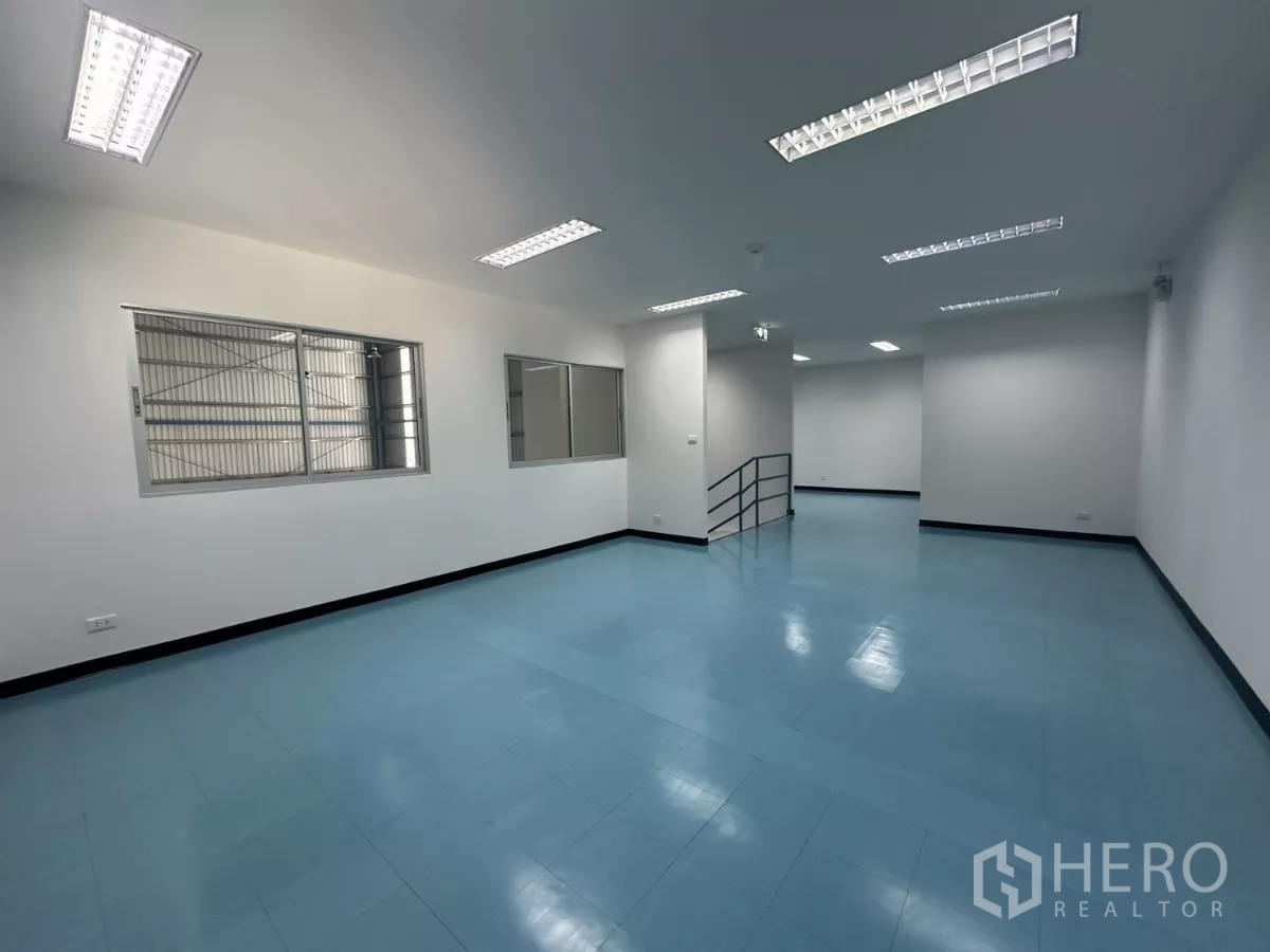 Factory for rent in Bang Phli, Samut Prakan - Open-plan mezzanine office with windows fitted with security grilles and strip lighting.