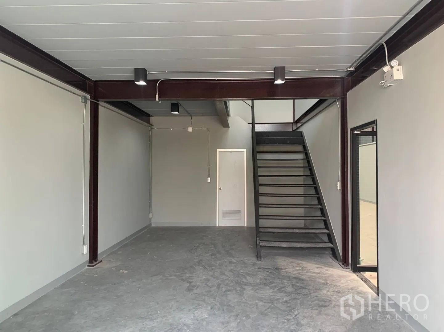 仓库 for rent in Bang Phli, Samut Prakan - 一层工作区可见钢梁、楼梯与服务门。