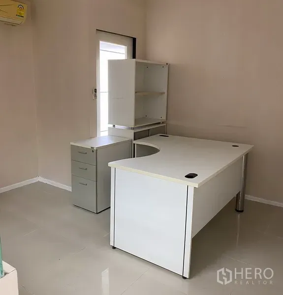 Office Space for rent in Din Daeng, Bangkok - Corner office with white executive desk, drawer cabinet and glossy tile flooring.