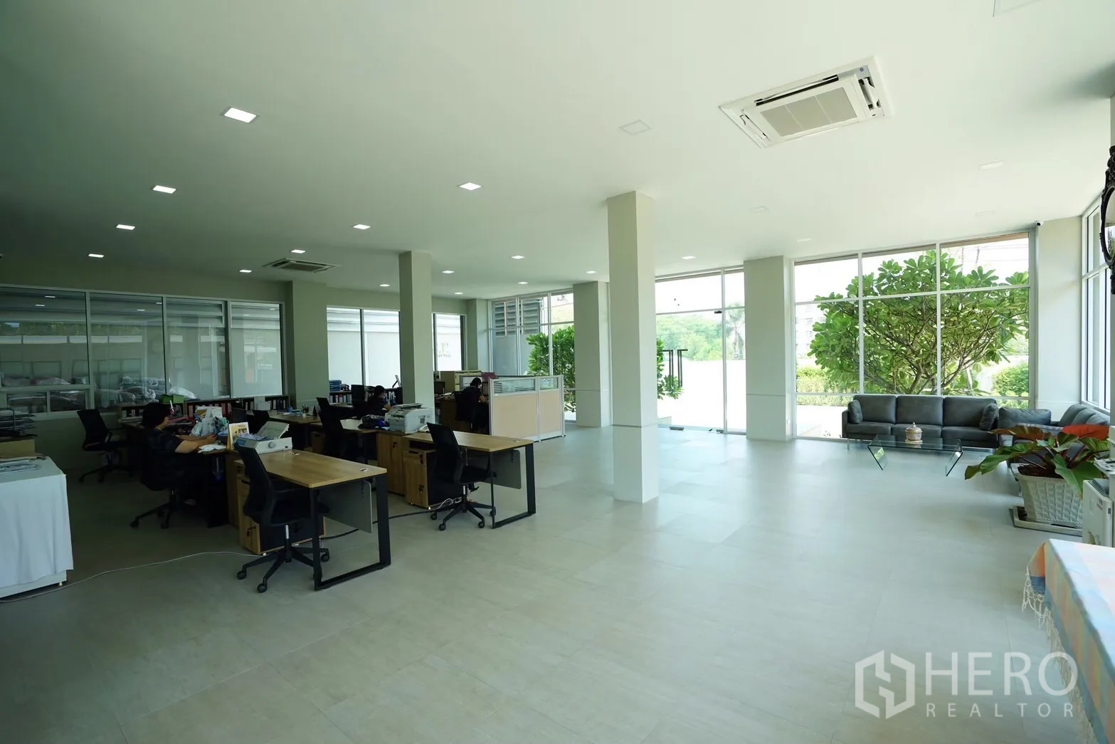 Factory for sale in Krathum Baen, Samut Sakhon - Air-conditioned open office with garden views through full-height windows.