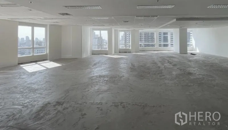 Office Space for rent - Unfurnished corner office level showcasing city skyline views through wide windows.
