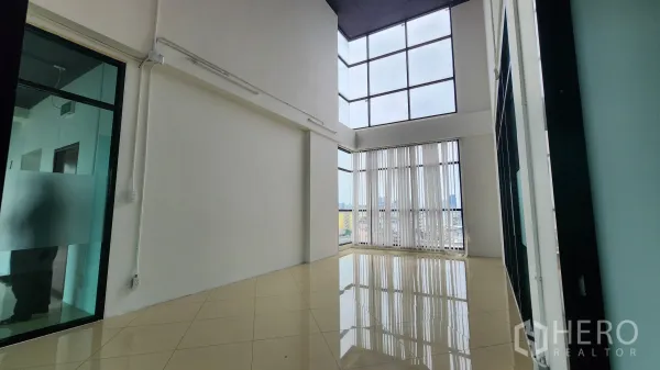 Office Space for rent in Yan Nawa, Bangkok - High-ceiling workspace with vertical blinds and frosted glass partition.