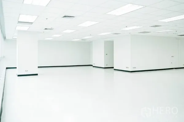 Office Space for rent in Watthana, Bangkok - Unfurnished office space with central columns and recessed ceiling lighting.