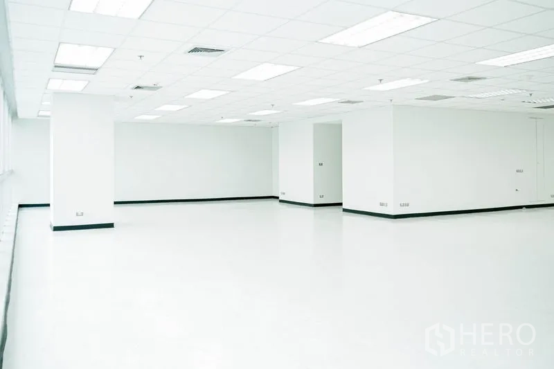 Office Space for rent in Watthana, Bangkok - Unfurnished office space with central columns and recessed ceiling lighting.