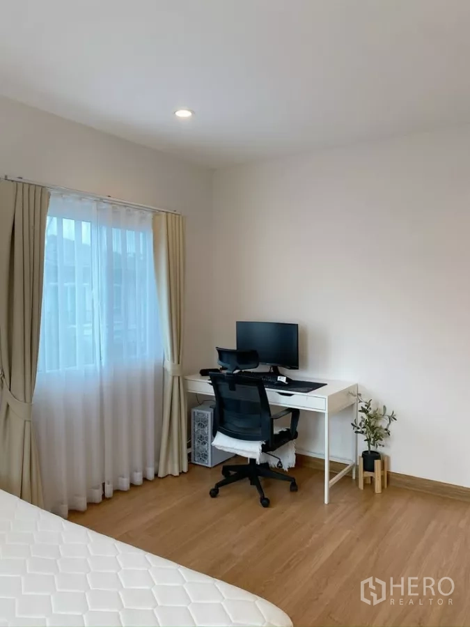 Detached House for sale in Sai Mai, Bangkok - Guest bedroom set up as a home office with desk and chair near a window.