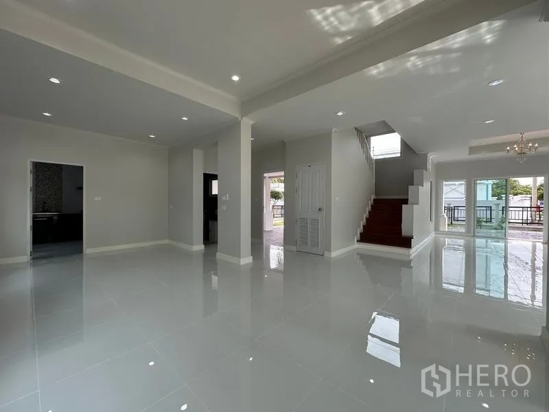 Detached House for sale in Lam Luk Ka, Pathum Thani - Open-plan ground floor with staircase, multiple doorways and tiled floors.
