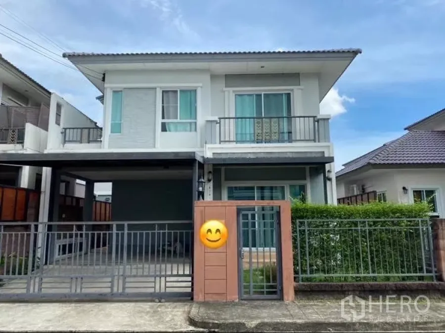 Detached House for rent or sale in Suan Luang, Bangkok - Two-storey detached house with gated parking and small front garden in a secure estate.