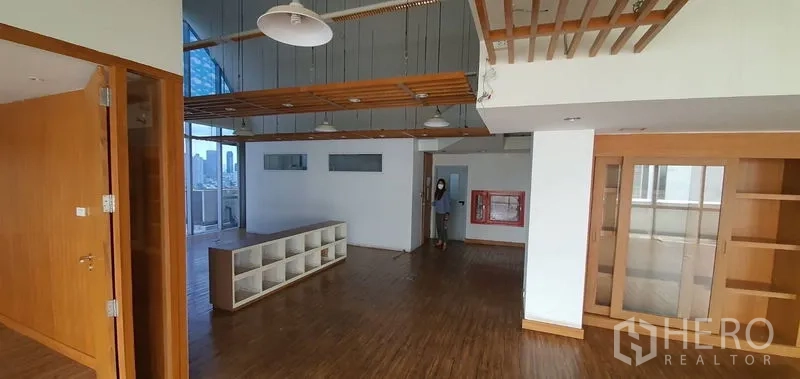 Office Space for rent in Watthana, Bangkok - Open workspace featuring suspended lights, central storage cubbies, and built-in shelving.
