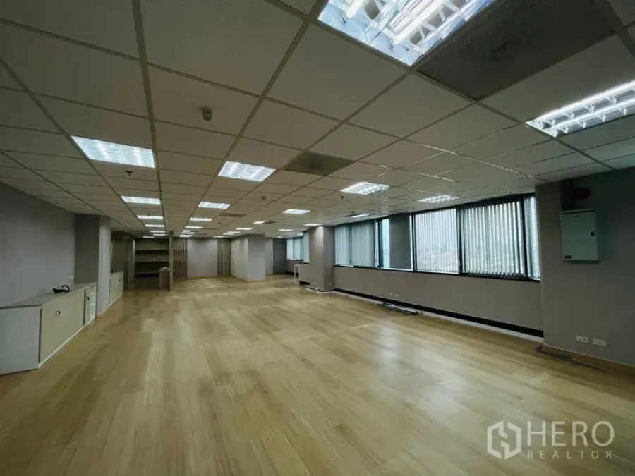 Office Space for rent - Spacious office floor plate with natural light and multiple ceiling lights.
