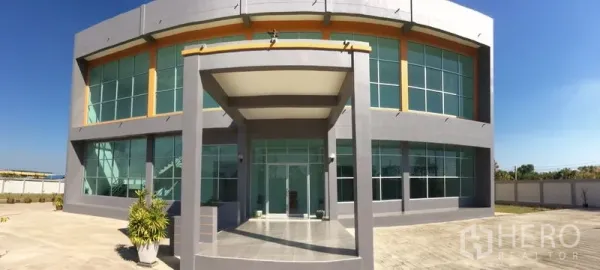 Factory for sale in Bang Sao Thong, Samut Prakan - Main entrance with covered porch and floor-to-ceiling glass windows of the office block.