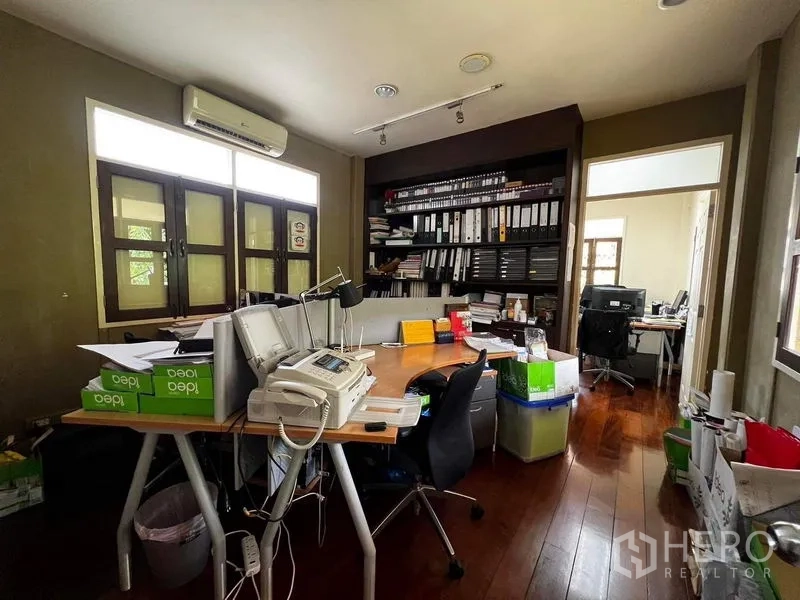Townhouse for rent - Bright office room with built-in shelving, desks and air conditioning.