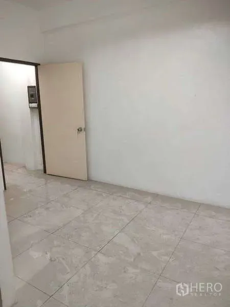 Shophouse for sale in Phra Khanong, Bangkok - Compact room with an open door and glossy floor tiles.