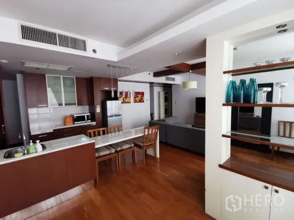 Condominium for rent in Pathum Wan, Bangkok - Dining bar and kitchen with wood cabinetry, pendant lights, and shelving in a Pathum Wan condominium.