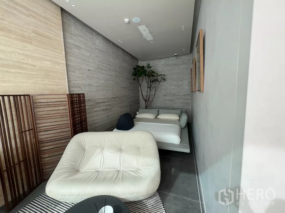 Retail Space for rent - Display room with lounge seat and low platform bed along a long wall.