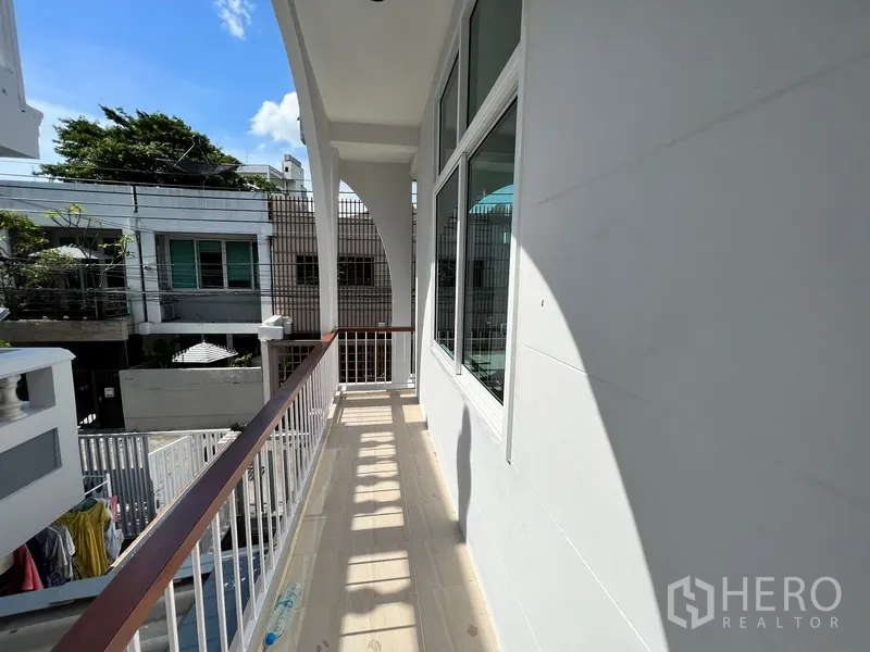 Home Office for rent in Watthana, Bangkok - Long covered balcony corridor with railings and arch detailing.