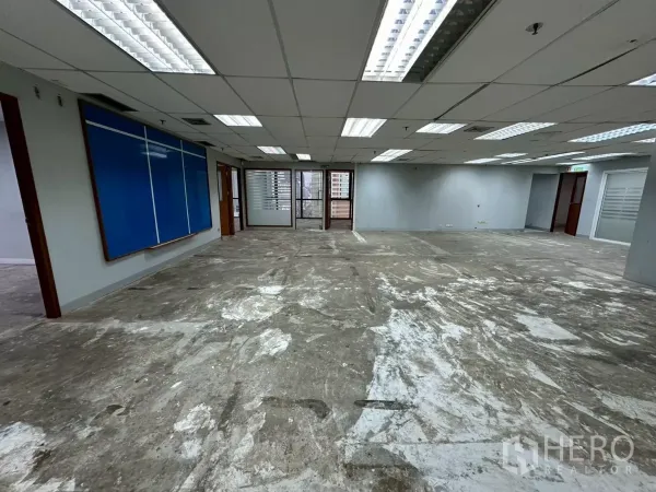 Office Space for rent in Khlong Toei, Bangkok - Central open area with blue presentation board and access to glass-walled corner offices.