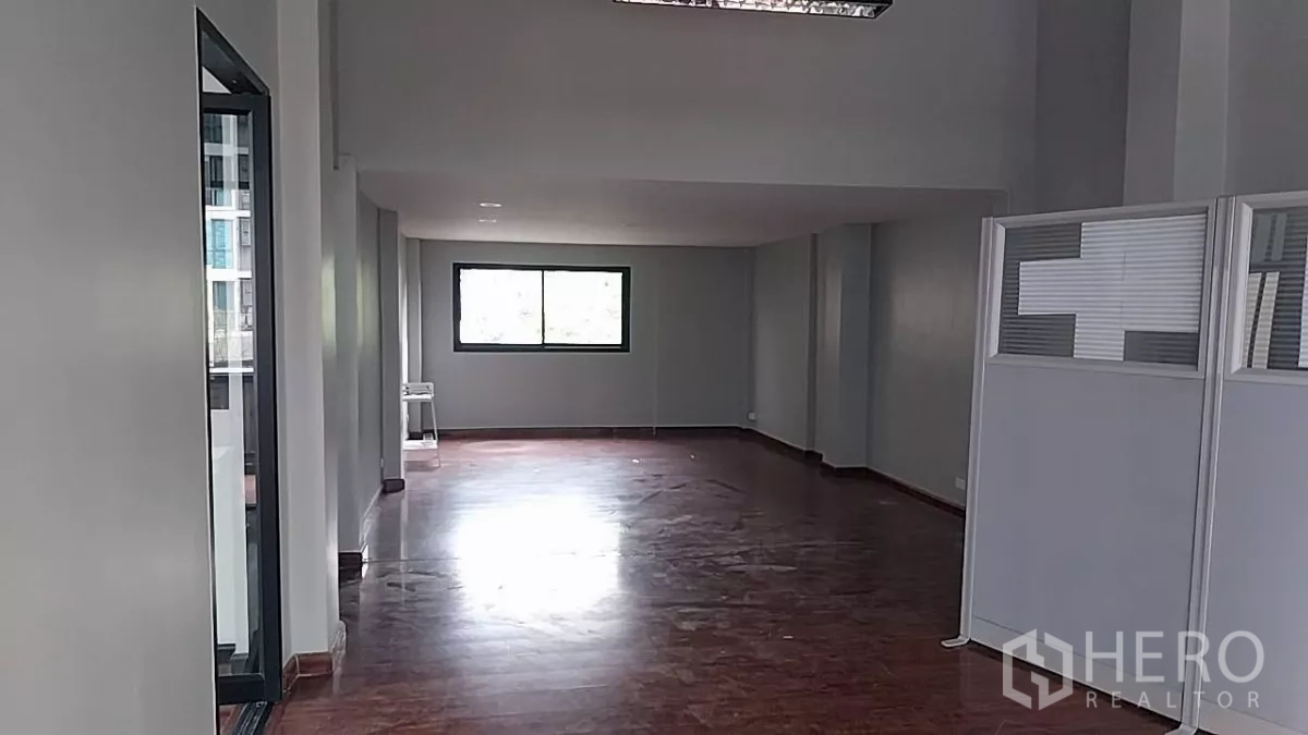 Retail Space for rent - Spacious hall with a window at the far end and movable partitions for flexible layouts.