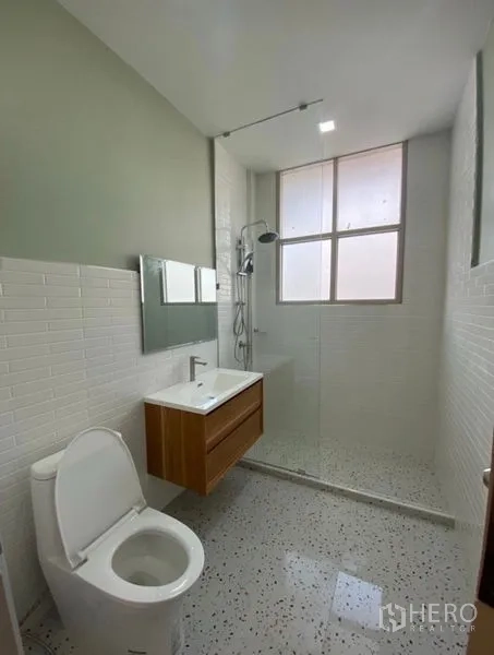 Townhouse for sale - Modern bathroom with walk-in shower, wall-mounted vanity and window light.