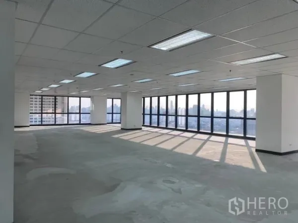 Office Space for rent in Din Daeng, Bangkok - Large unfurnished office showing panoramic city‑facing glazing and suspended grid ceiling.
