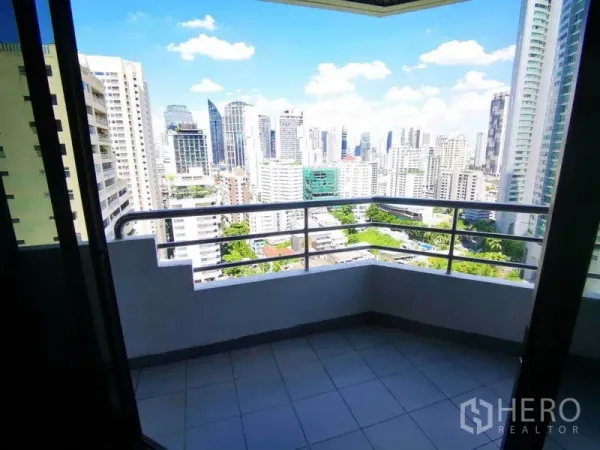 Condominium for rent in Khlong Toei, Bangkok - Private condo balcony with railings overlooking Bangkok skyline on a clear day.