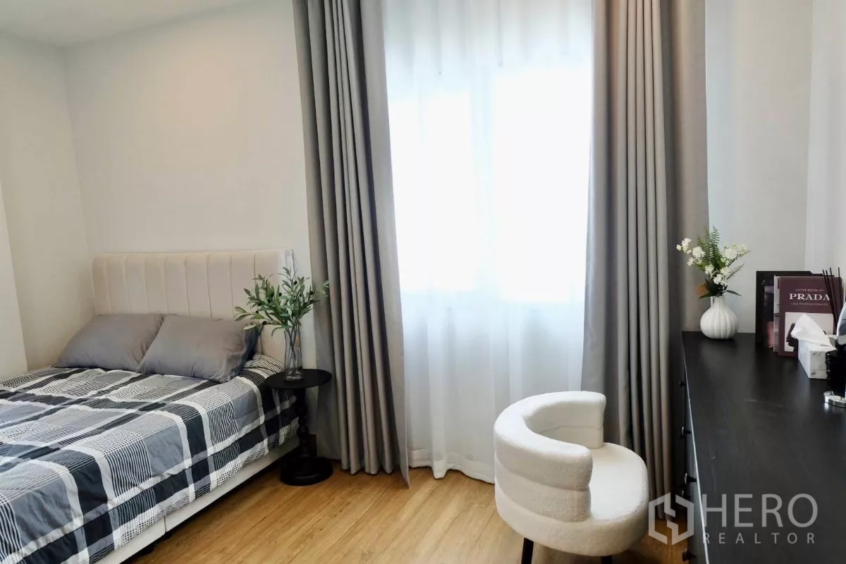 Detached House for sale in Bang Phli, Samut Prakan - Guest bedroom with bed and plaid bedding, double-layer curtains, side table and dressing corner