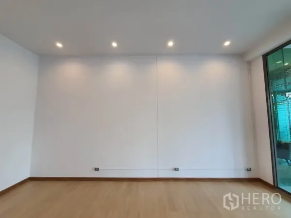 Retail Space for rent in Watthana, Bangkok - Bright retail unit interior with white walls, wood flooring and recessed LED spotlights.